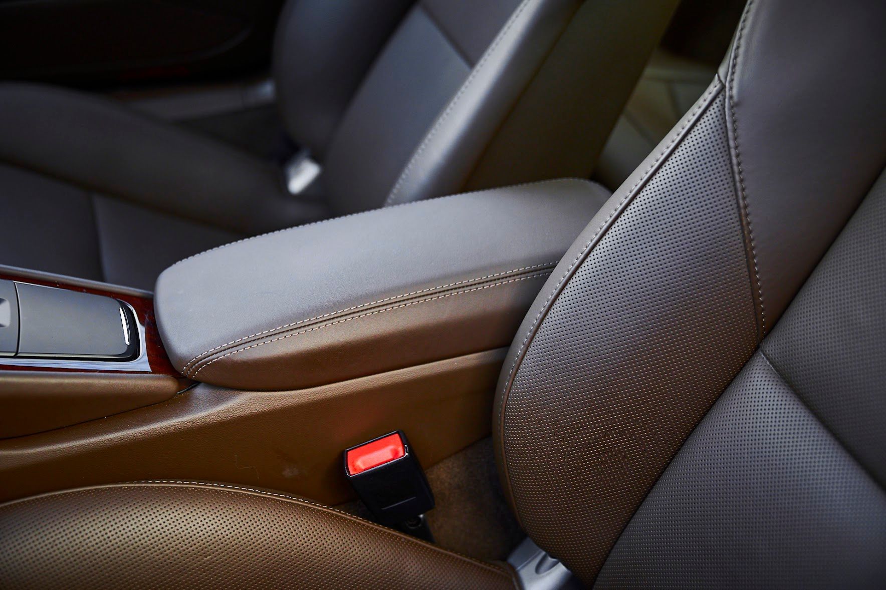 A close up of the arm rest of a car seat