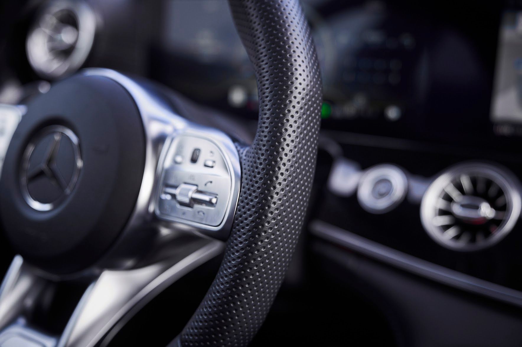 A close up of a steering wheel in a car