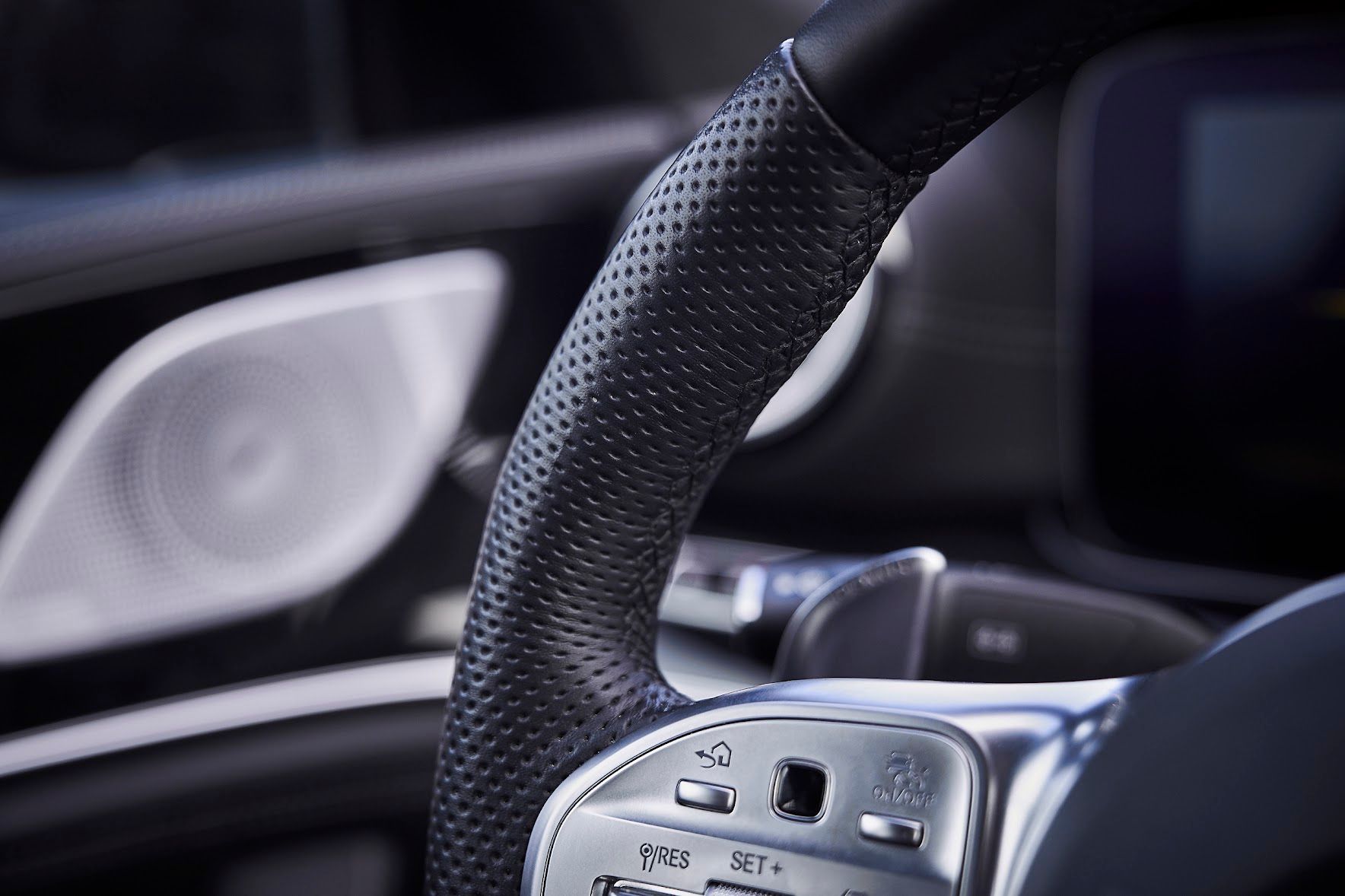 A close up of a steering wheel in a car