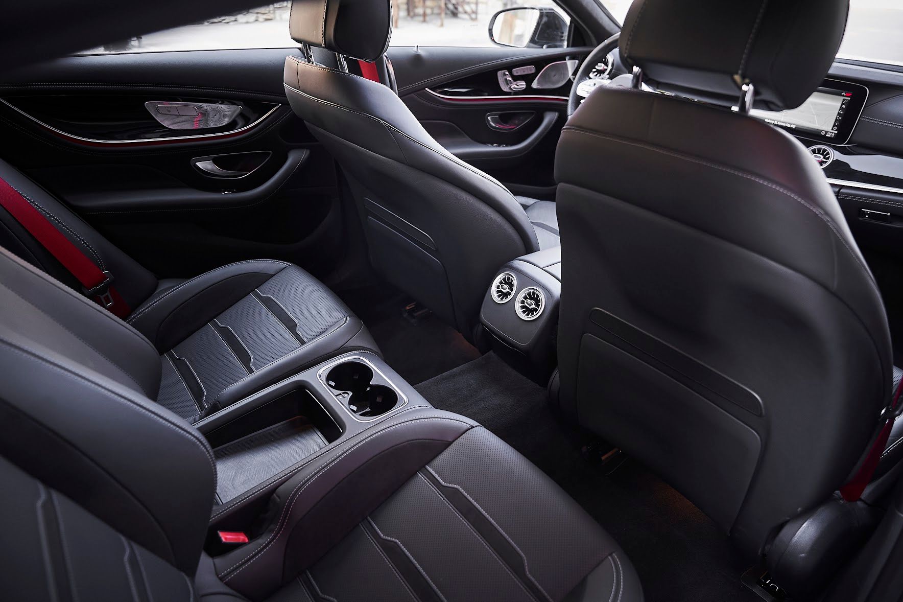 The interior of a car with black leather seats and a center console