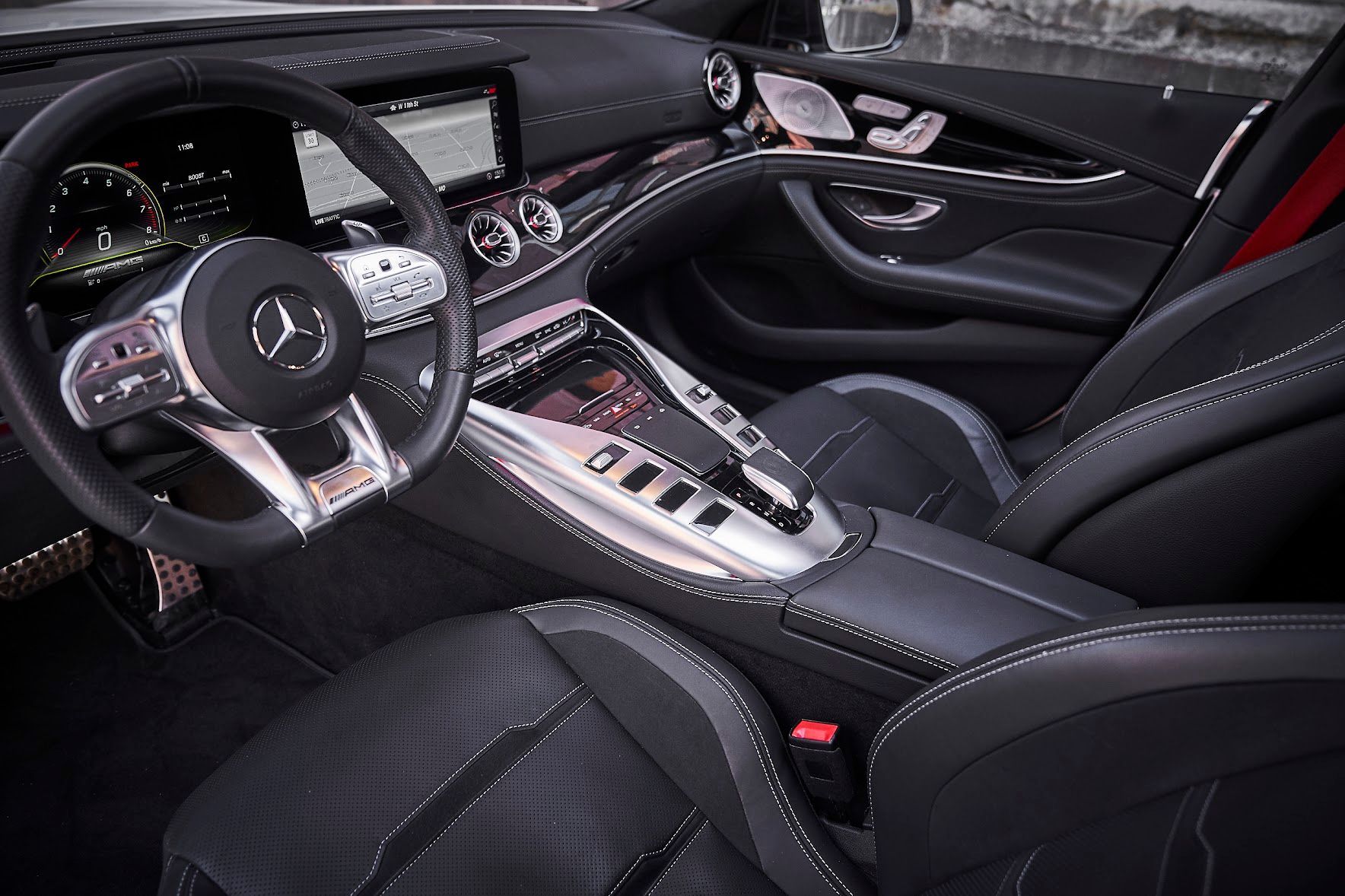 The interior of a mercedes amg gt63 s has a steering wheel and a dashboard.