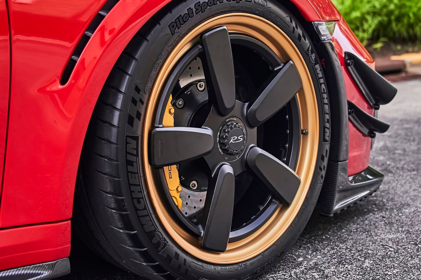 A close up of a car wheel with a michelin tire on it