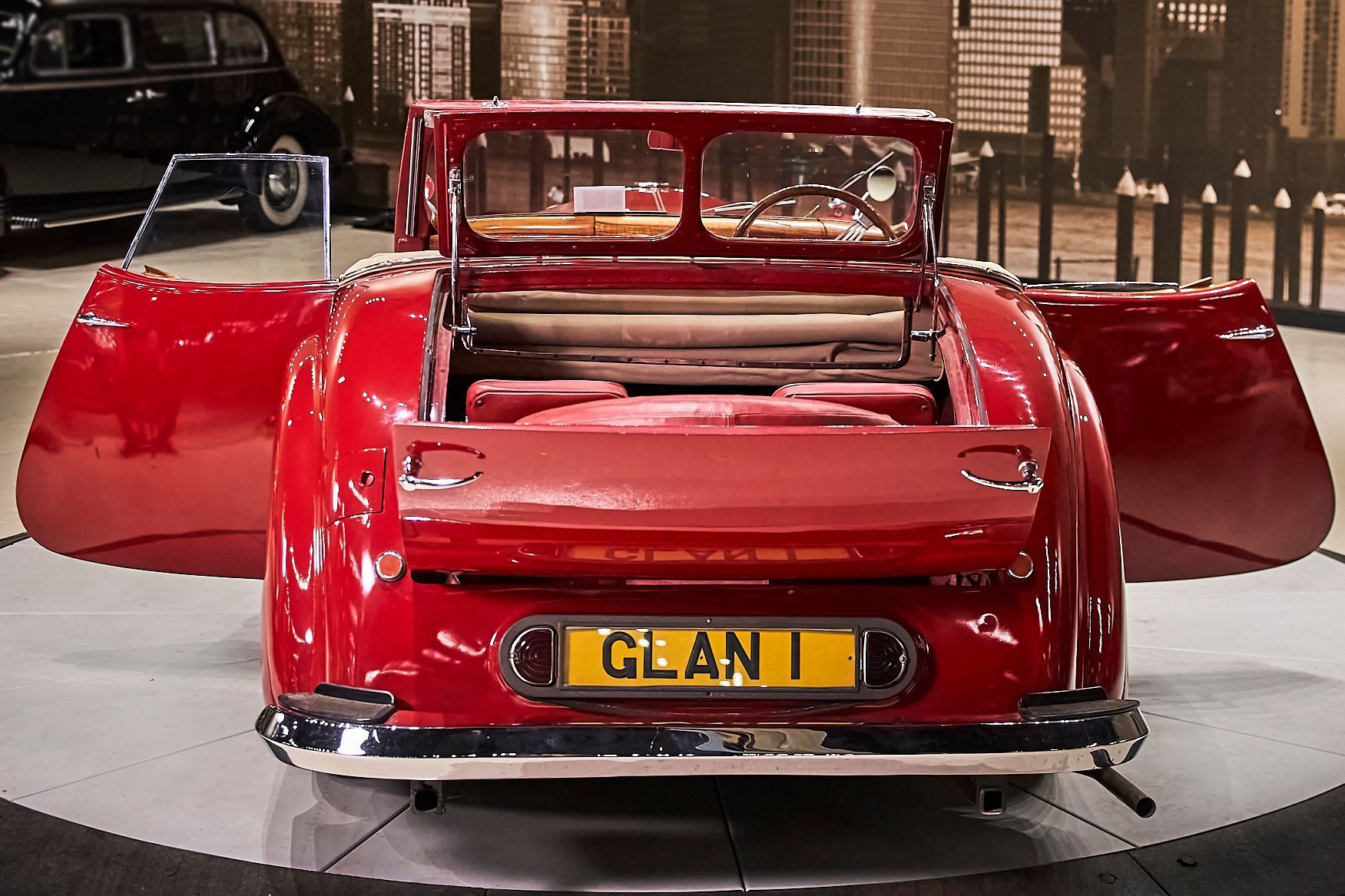 A red car with a license plate that says glan on it