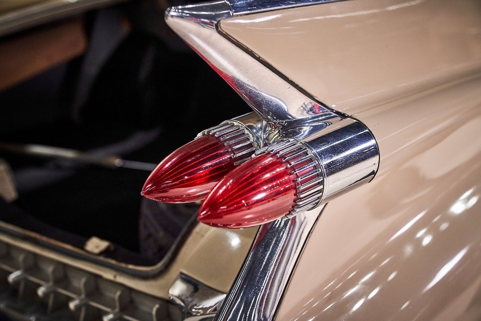 A close up of the tail light of an old car.