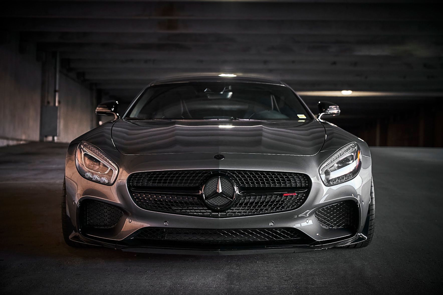 A mercedes benz gt is parked in a parking garage.
