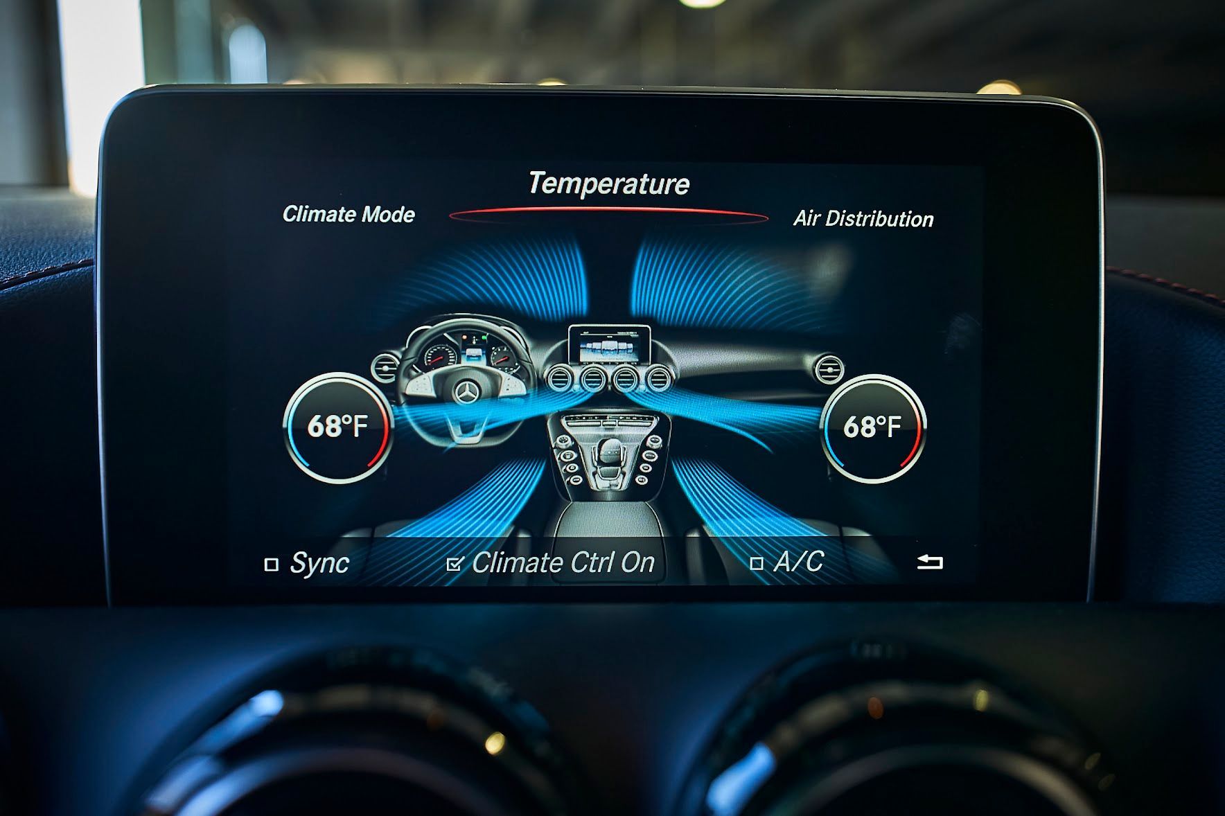 A close up of a car dashboard with a screen showing the temperature.