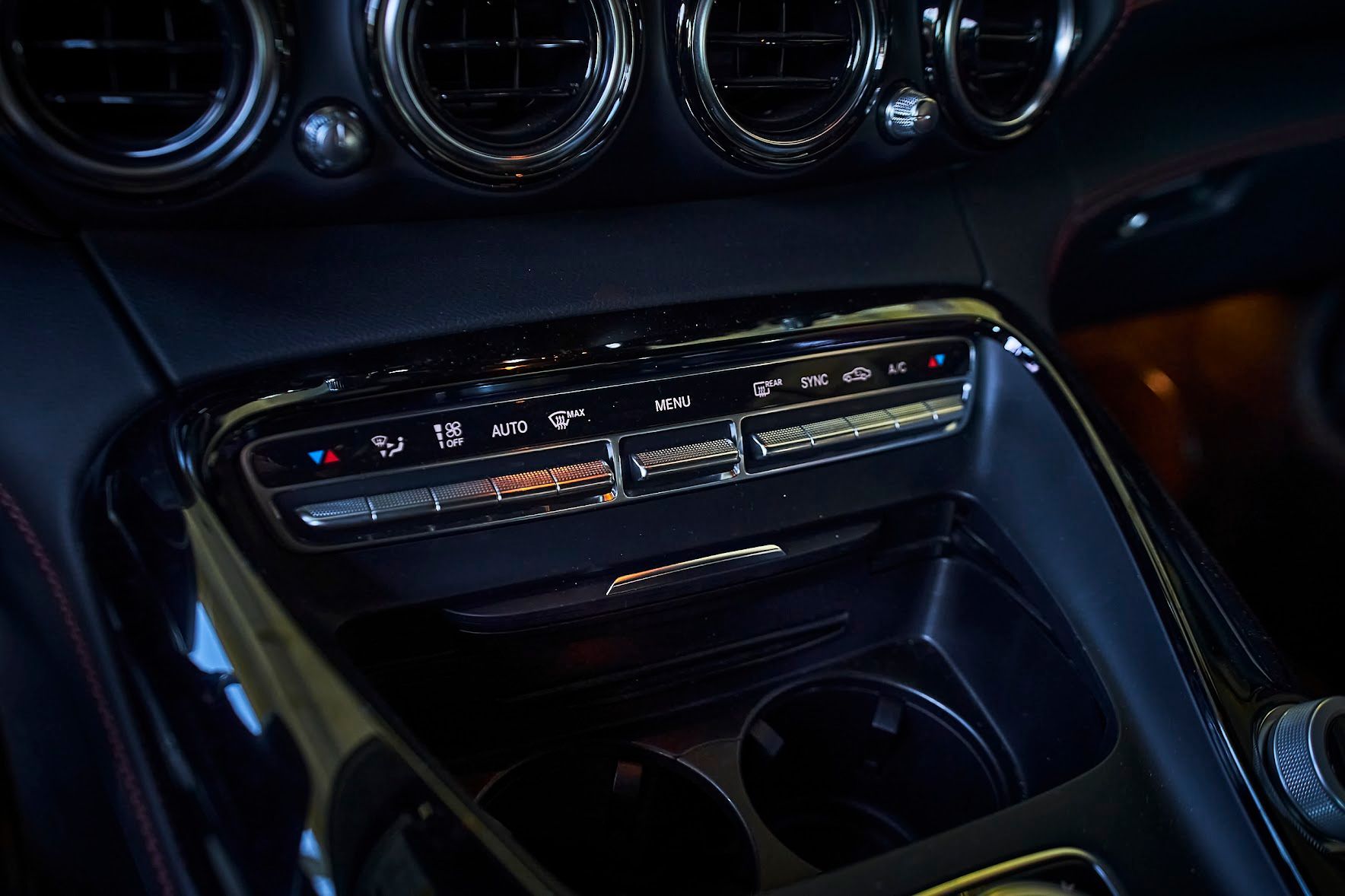 A close up of a car 's a/c control panel.