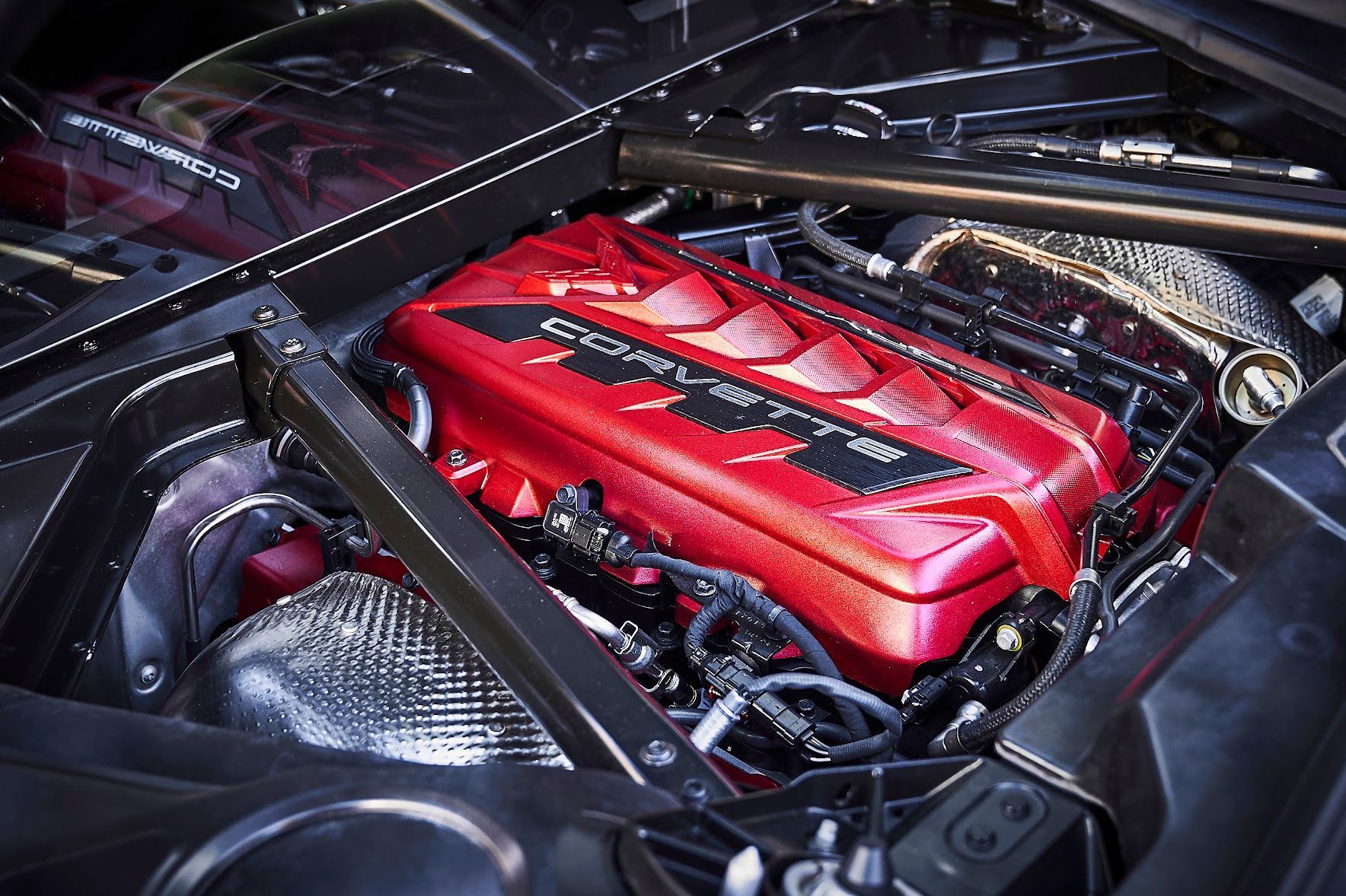 A close up of a red engine in a car