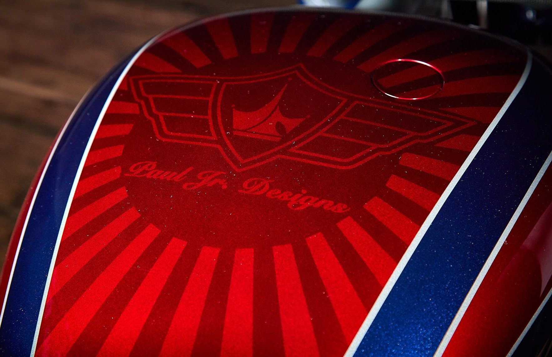 A red and blue motorcycle with paul jr designs written on it