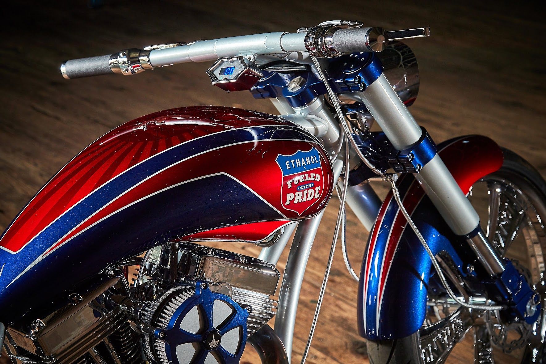 A red white and blue motorcycle with the word pride on the tank