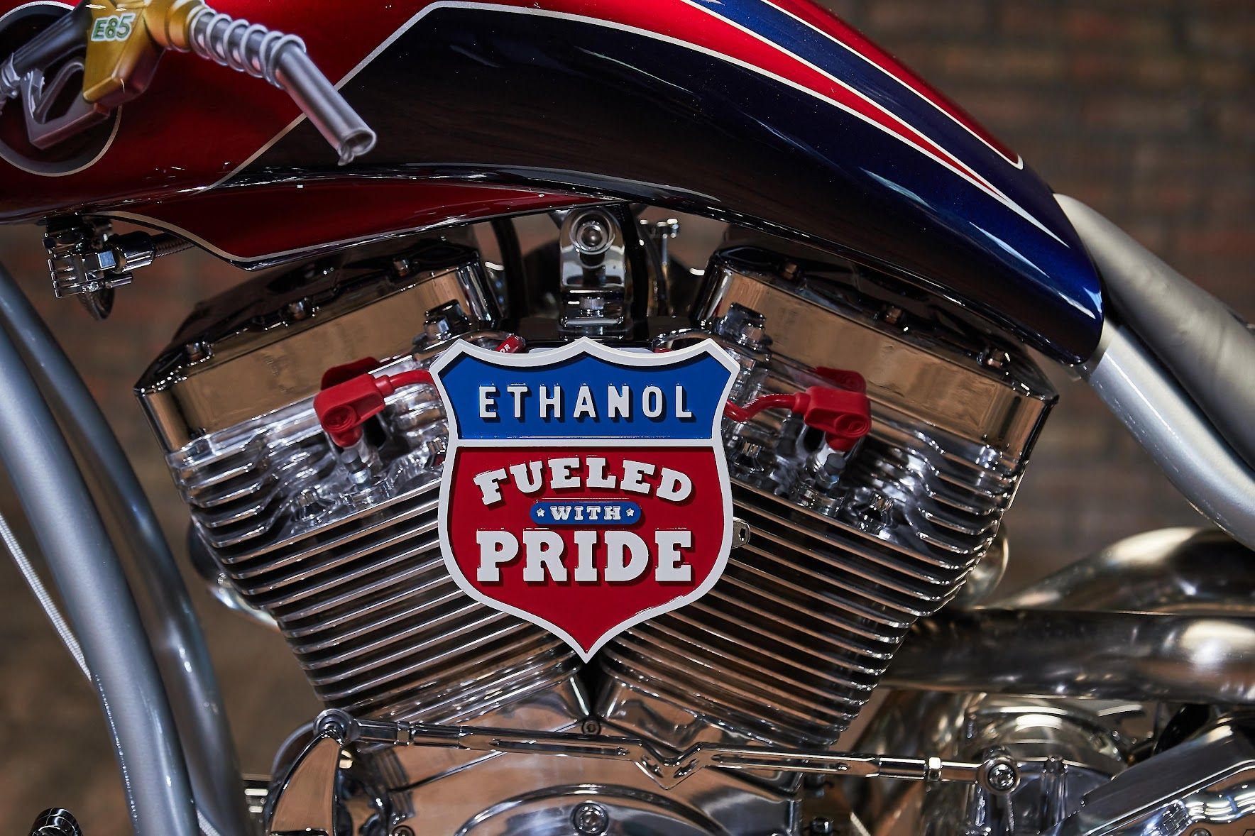 A motorcycle with a fueled pride sign on the engine