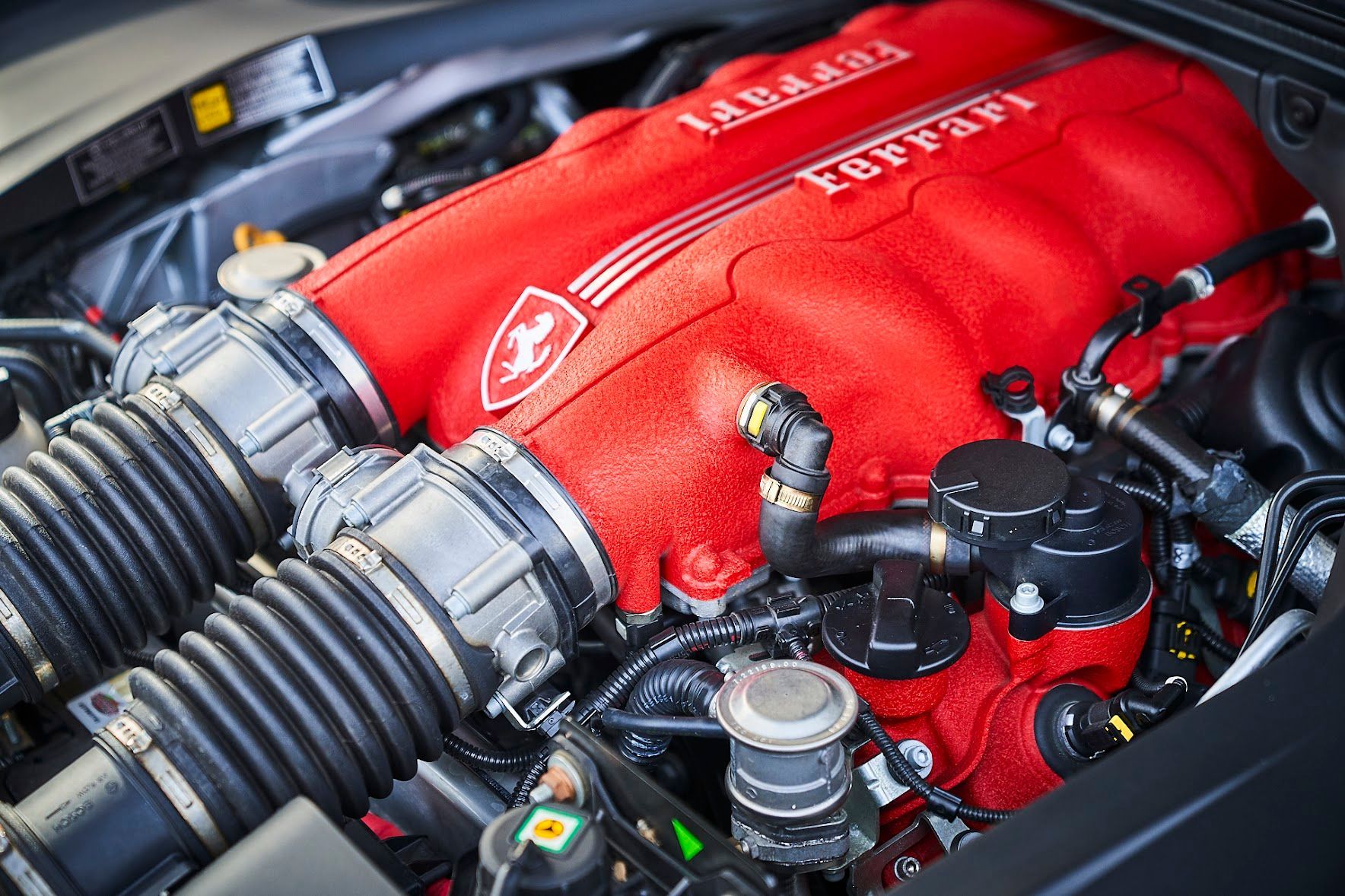 A close up of the engine of a ferrari car.