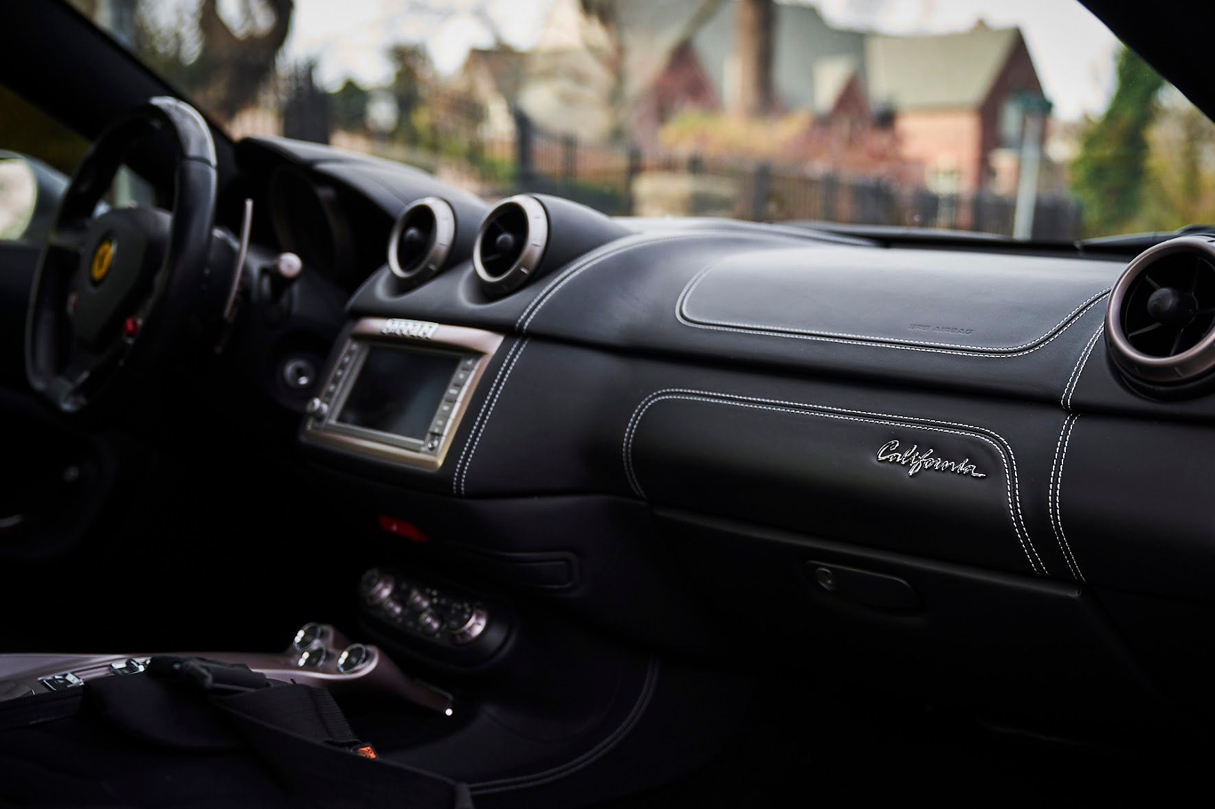 The interior of a ferrari car with a steering wheel and dashboard.