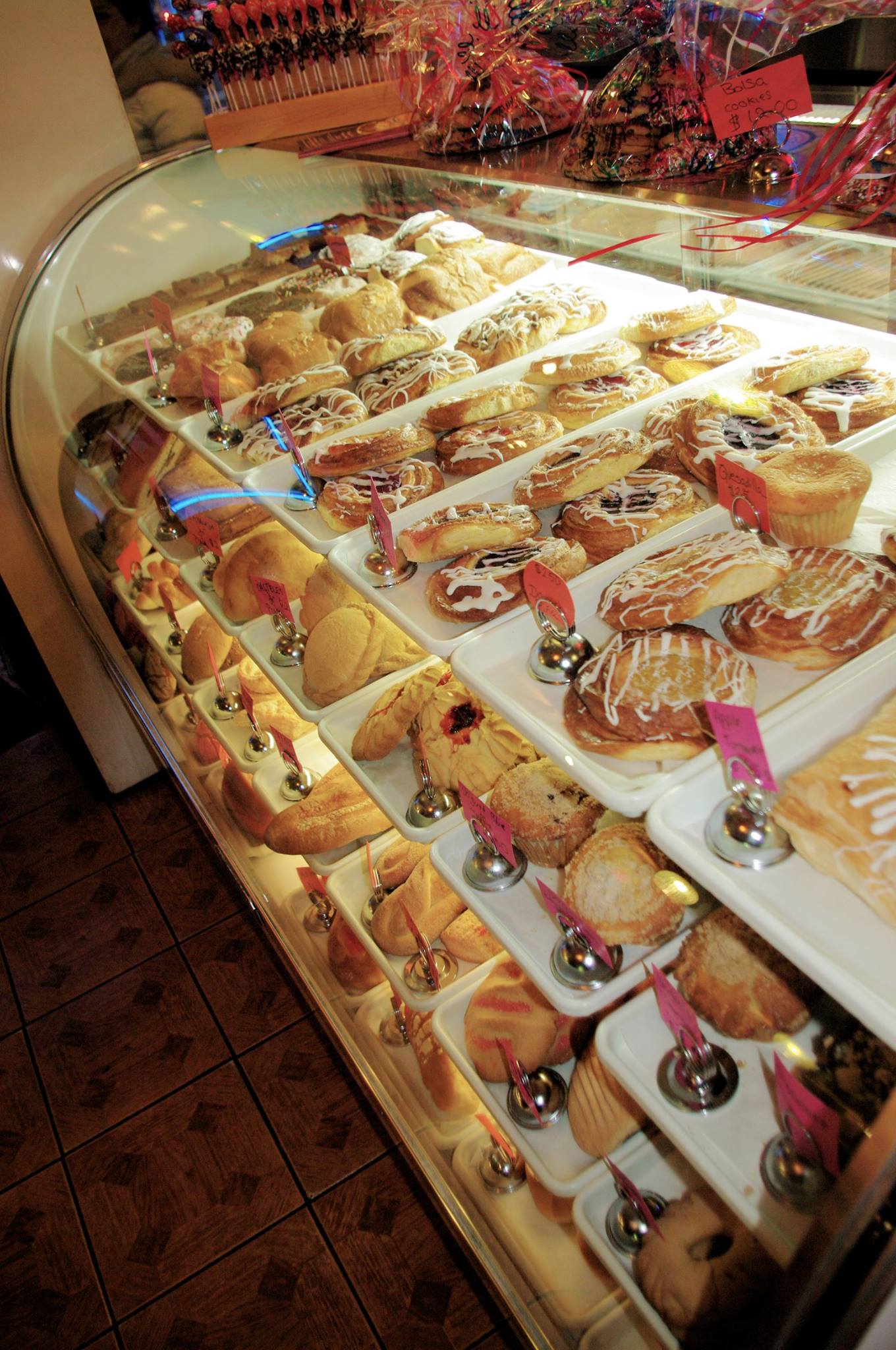 A display case filled with many different types of pastries