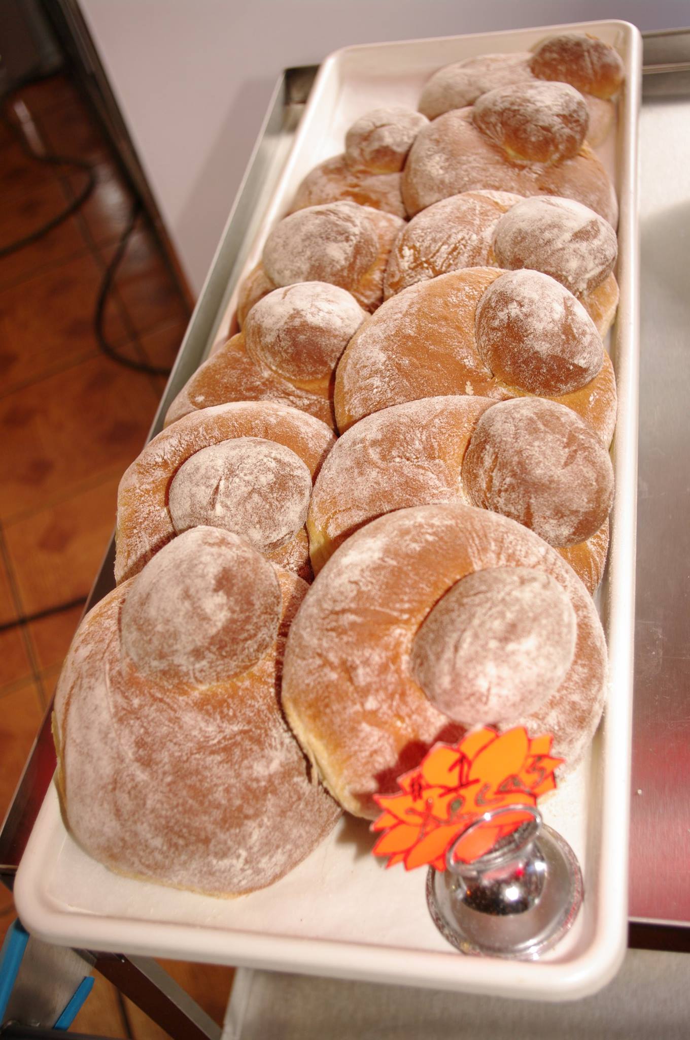 A tray of donuts with a price tag on it