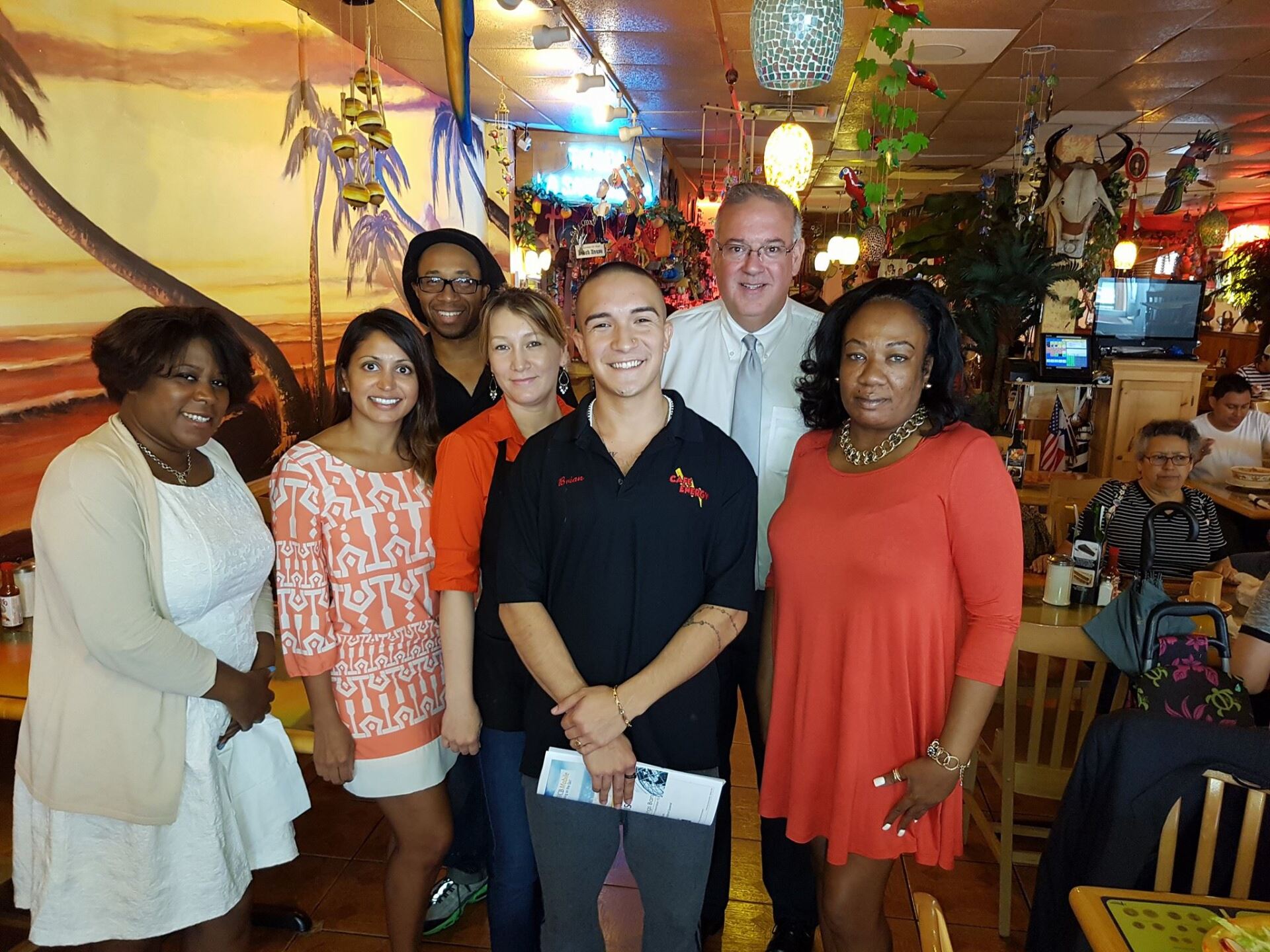 A group of people posing for a picture in a restaurant