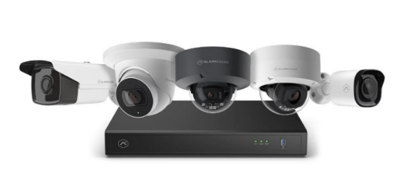 A group of security cameras sitting on top of a black box.