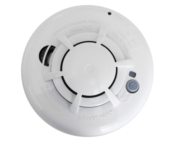 A white smoke detector with a button on it