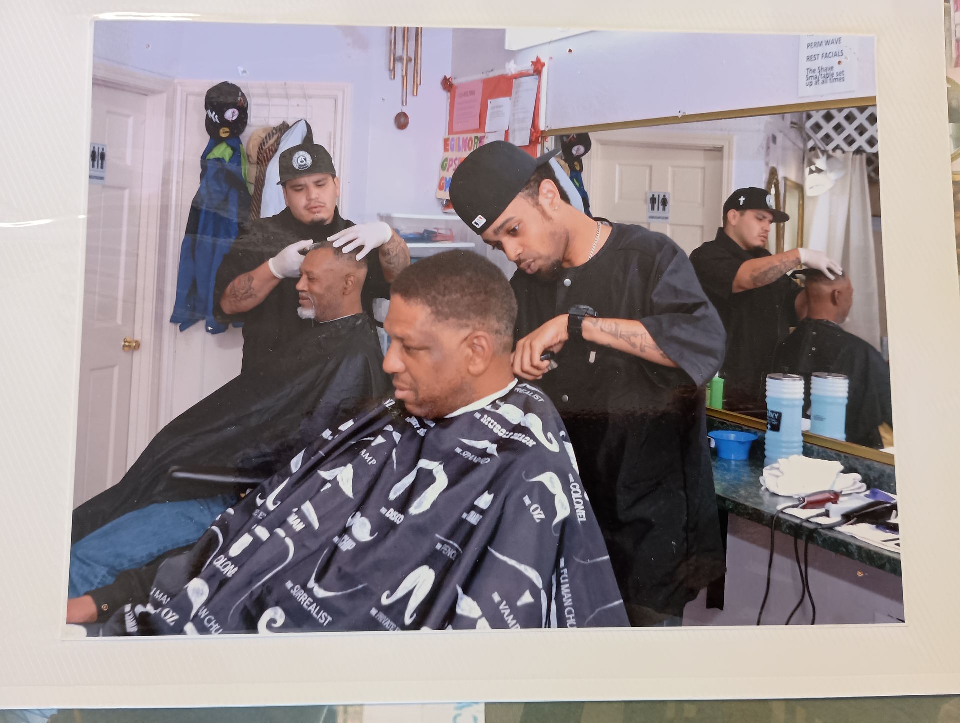 A man is getting his hair cut at a barber shop