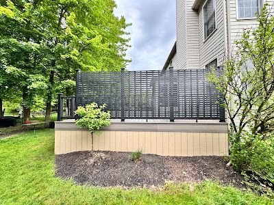 There is a fence in the backyard of a house.
