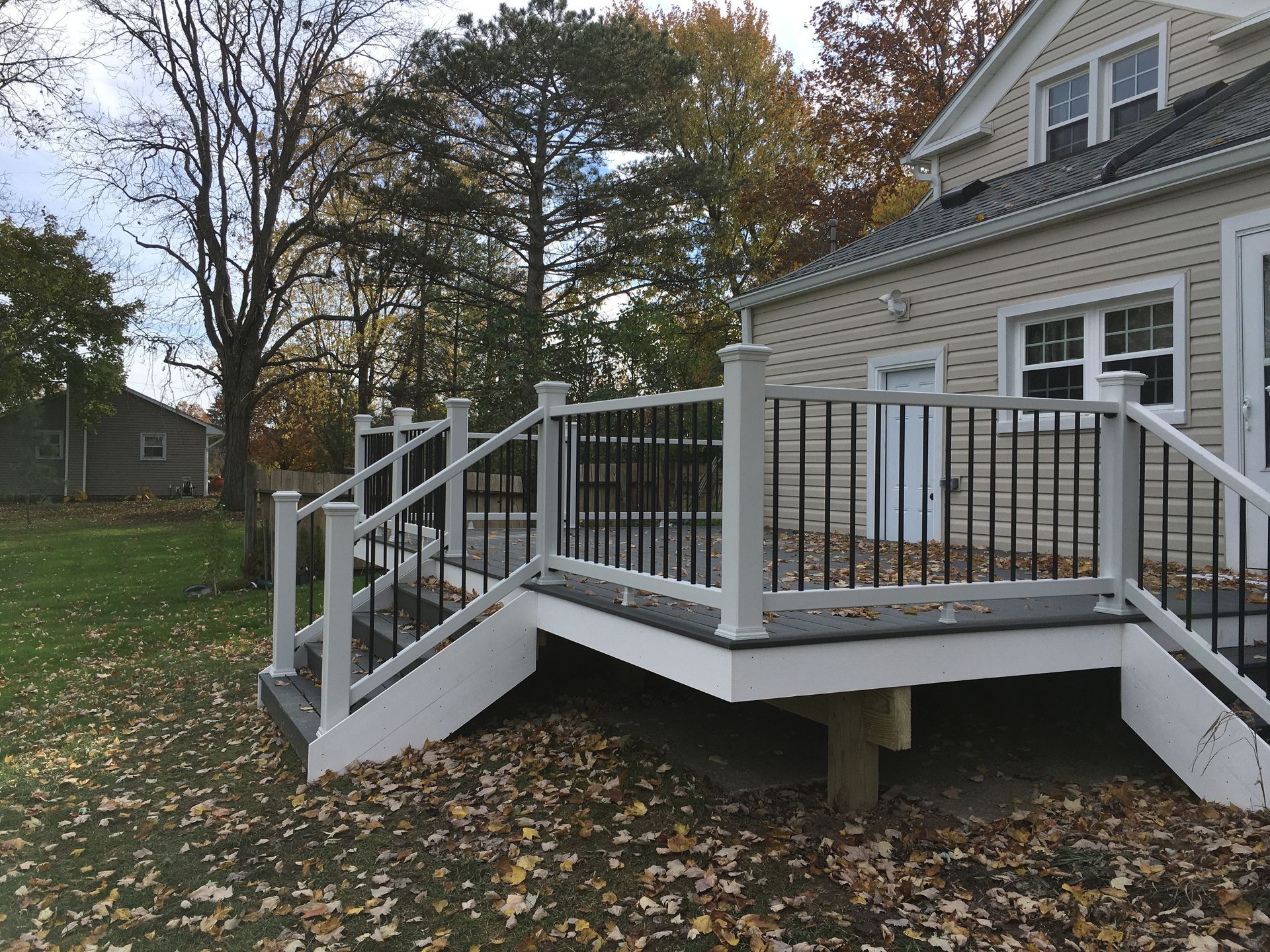 A house with a deck and stairs in front of it