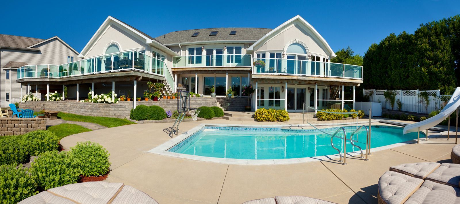 A large house with a large swimming pool in front of it