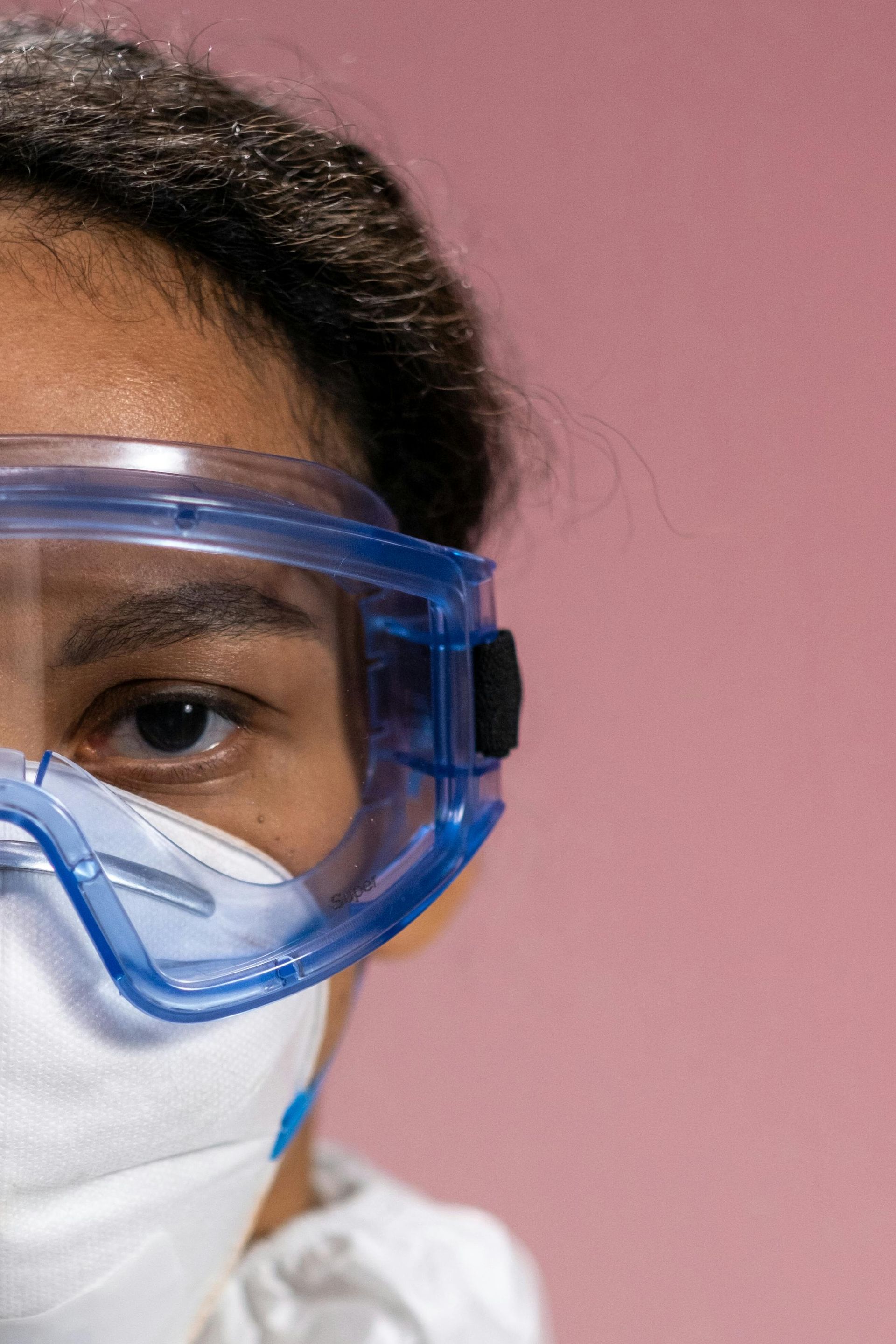 A close up of a person wearing a mask and goggles.