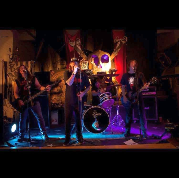 A group of people are standing on a stage playing instruments.