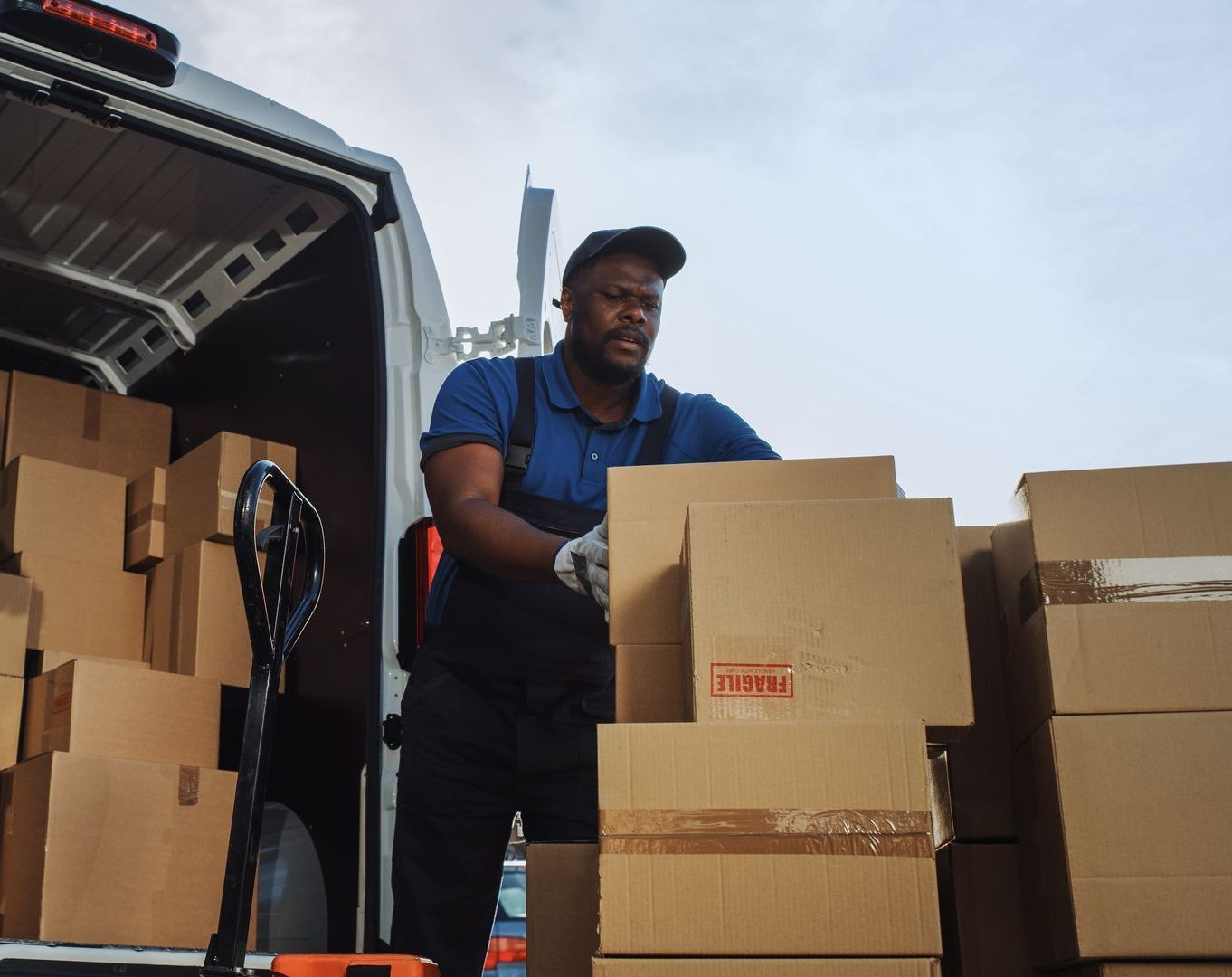 A man is loading boxes into a van that says zcbi