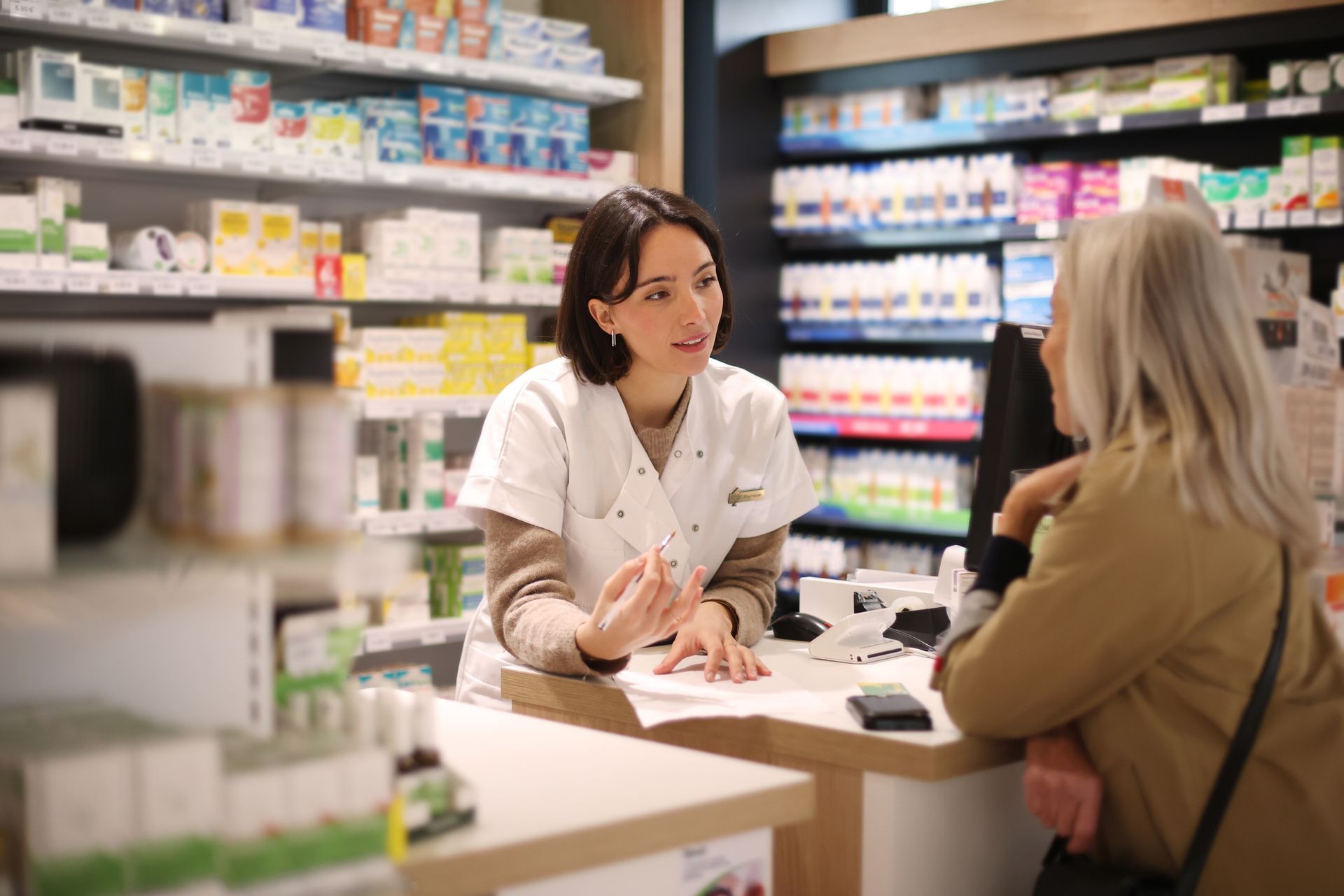 Pharmacist giving recommendations to a senior customer.
