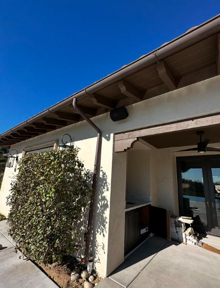 A house with a gutter on the side of it