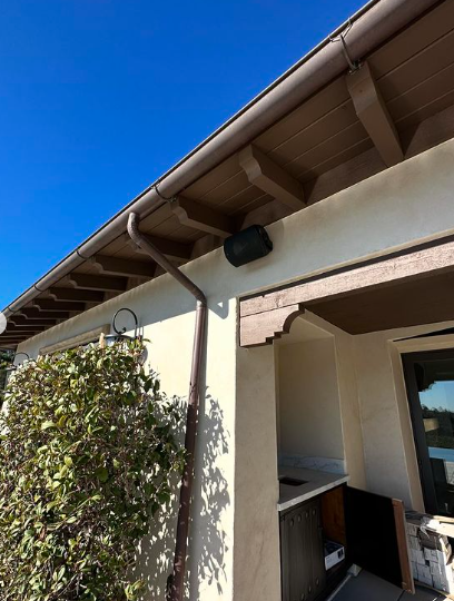 A house with a gutter on the side of it