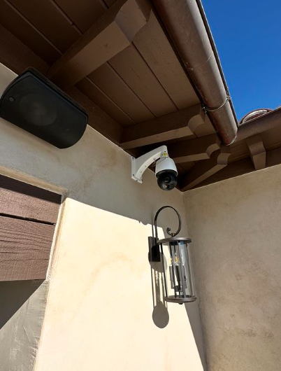 A security camera is mounted on the side of a building