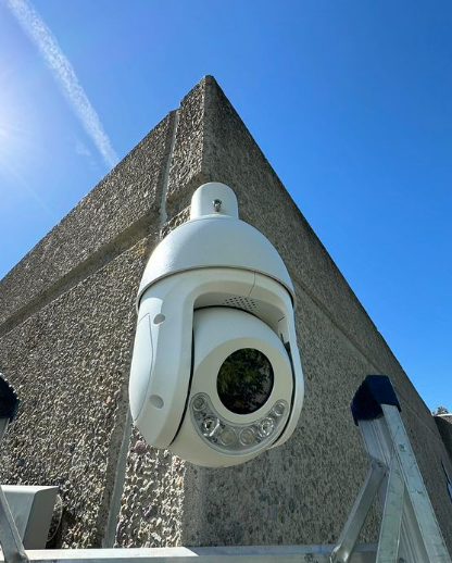 A security camera is mounted on the side of a building