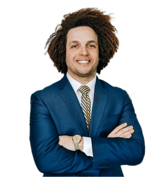 A man with curly hair is wearing a blue suit and tie