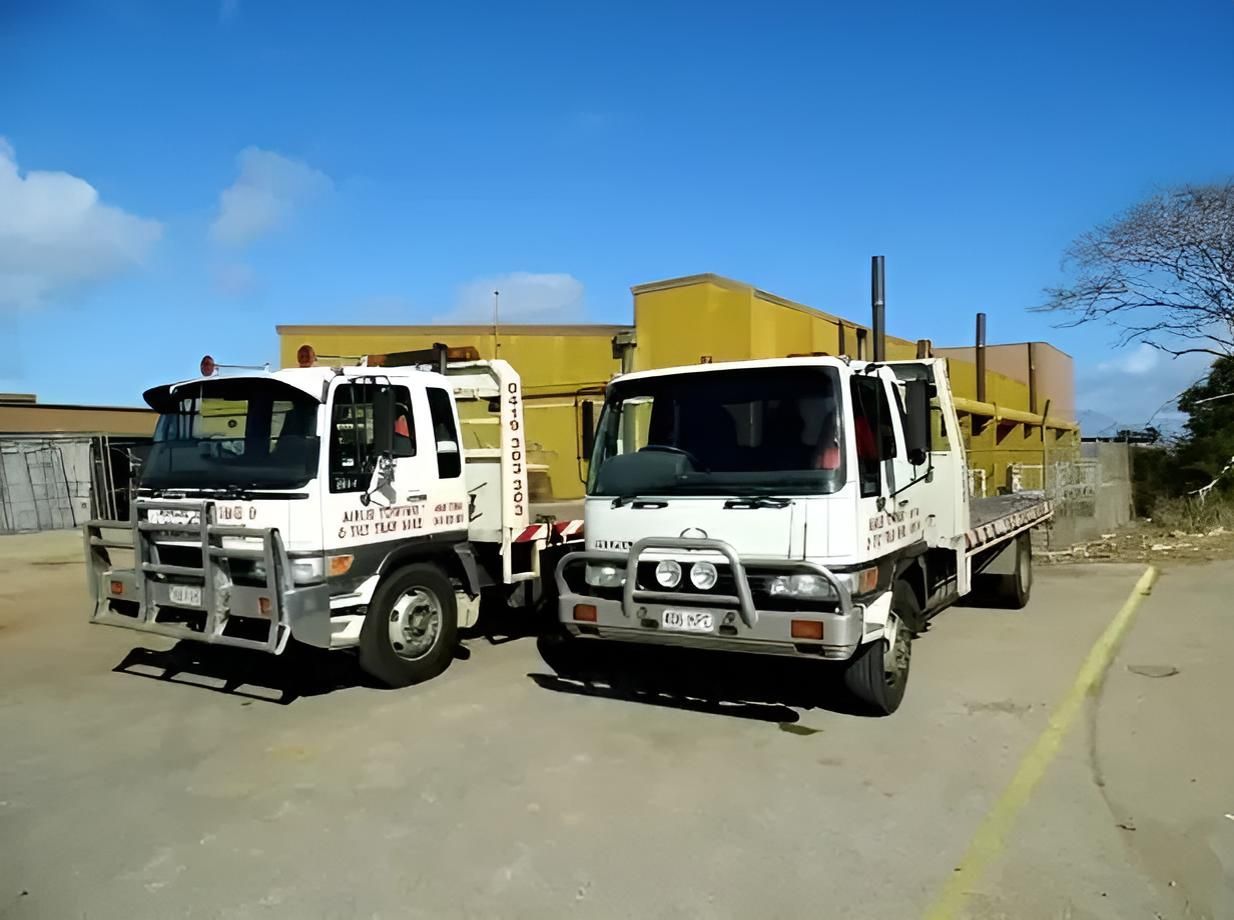 Two Tow Trucks Are Parked Next to Each Other in a Parking Lot — Airlie Towing & Tilt Tray Hire In Cannonvale, QLD