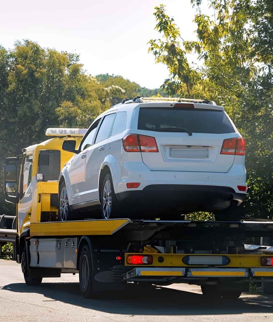 A White SUV is Being Towed by a Tow Truck — Airlie Towing & Tilt Tray Hire In Cannonvale, QLD