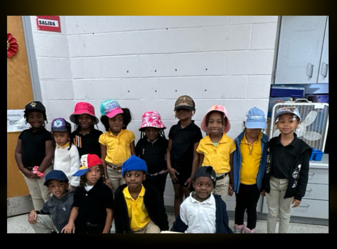 a group of children wearing hats pose for a picture