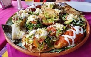 A plate of mexican food is sitting on a table.