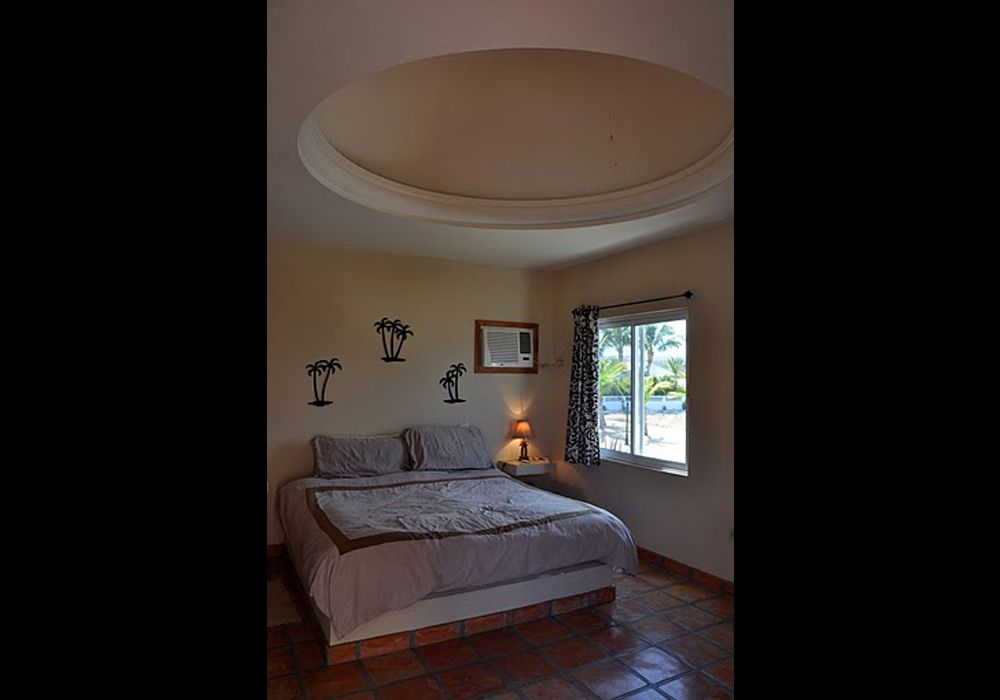 A bedroom with a king size bed and a window