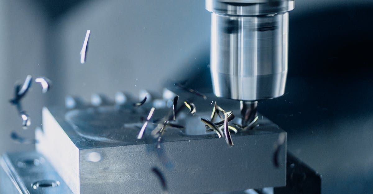 A machine is cutting a piece of metal in a factory.