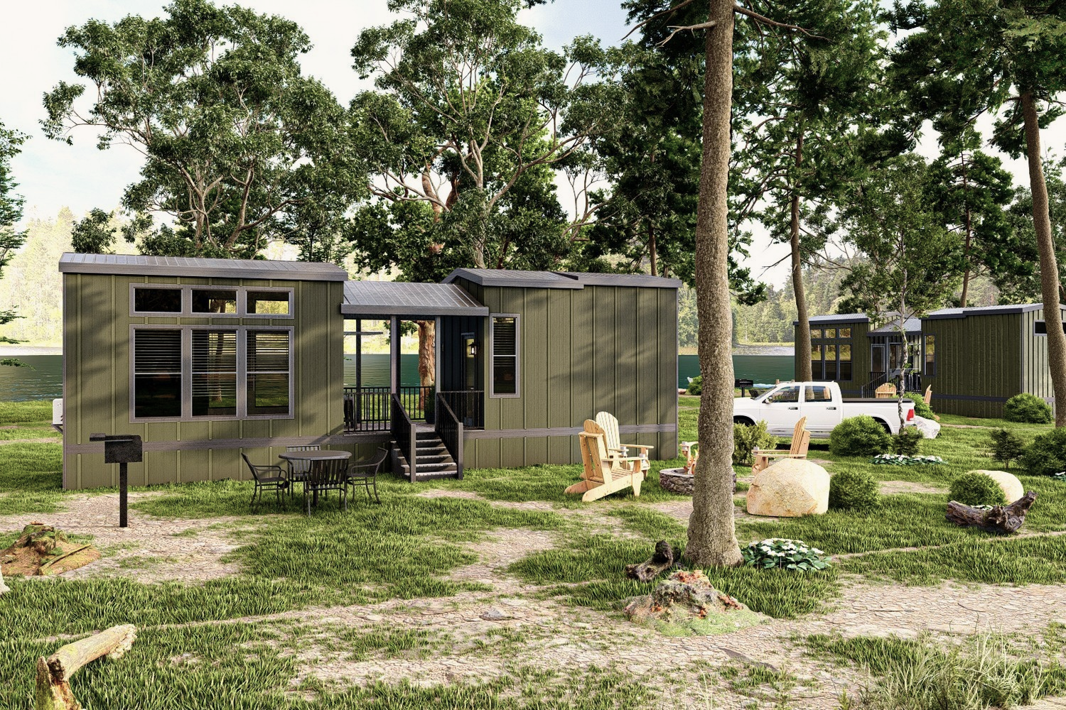 Green modular cabins in a wooded setting. A white pickup truck is parked nearby.