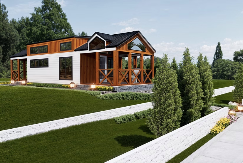 Modern tiny house with white and wood siding, set on a green grassy hill with a white walkway and trees.