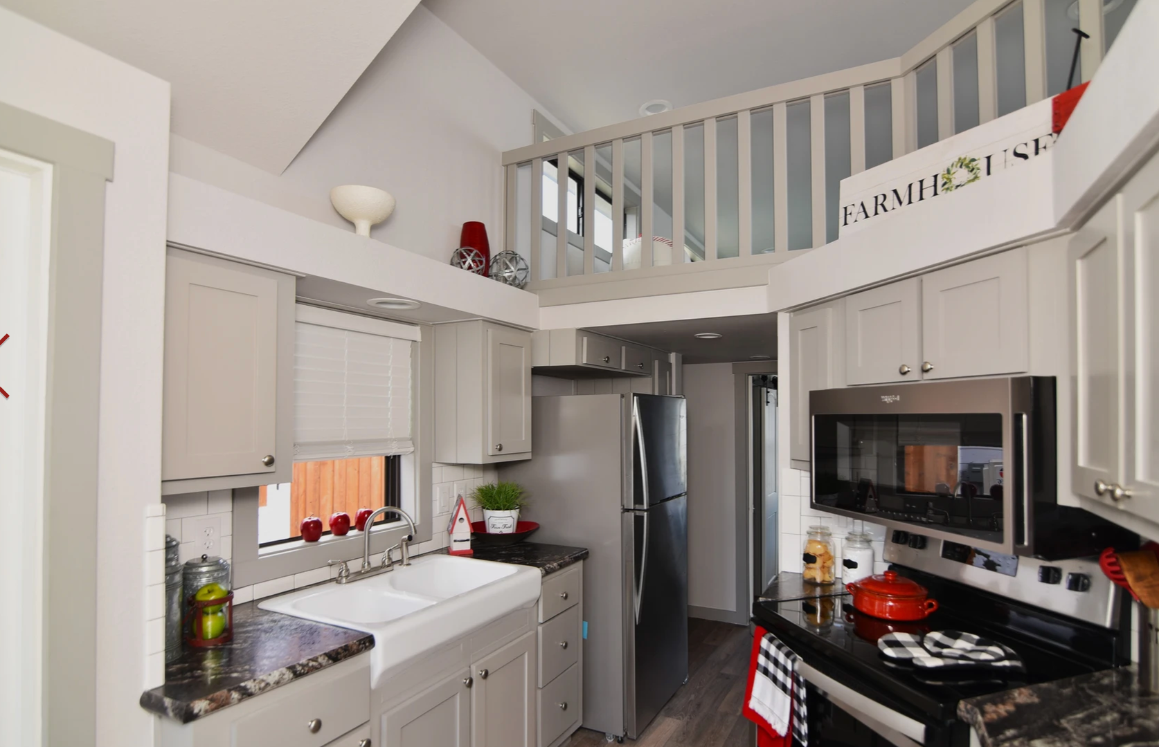A kitchen with a sign that says farmhouse on it