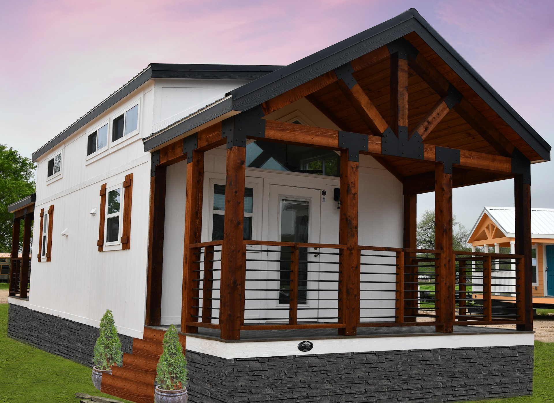 A white house with a wooden porch and stairs.