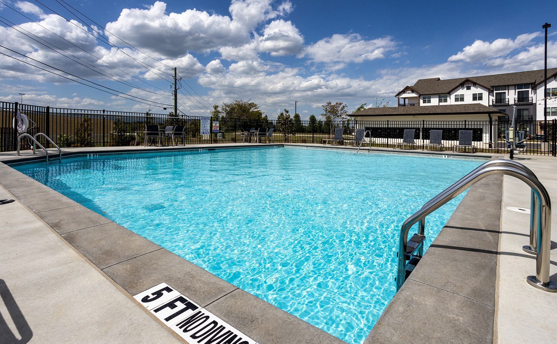 Hixson, TN, Apartments for Rent - Ridgeview at Northgate - Shimmering Saltwater Swimming Pool with Spacious Sundeck, Lounge Seats, Tables, and Chairs.