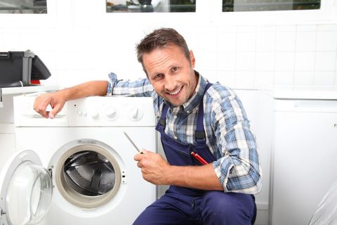 Man with repaired dryer after a home appliance service in Auckland