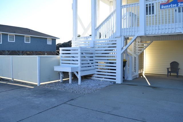 Pool deck installation with modern white stairs and privacy panel enclosure by deck and pool contractors