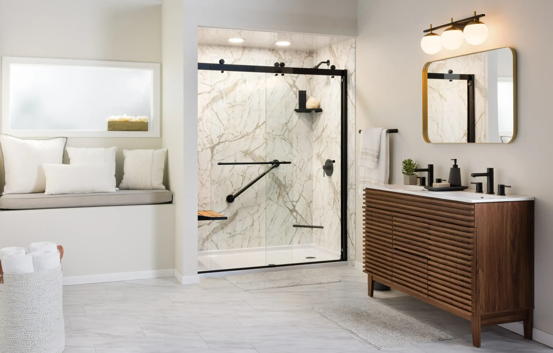 Bright modern bathroom with walk-in shower, tub bench, and wooden vanity with mirror lighting