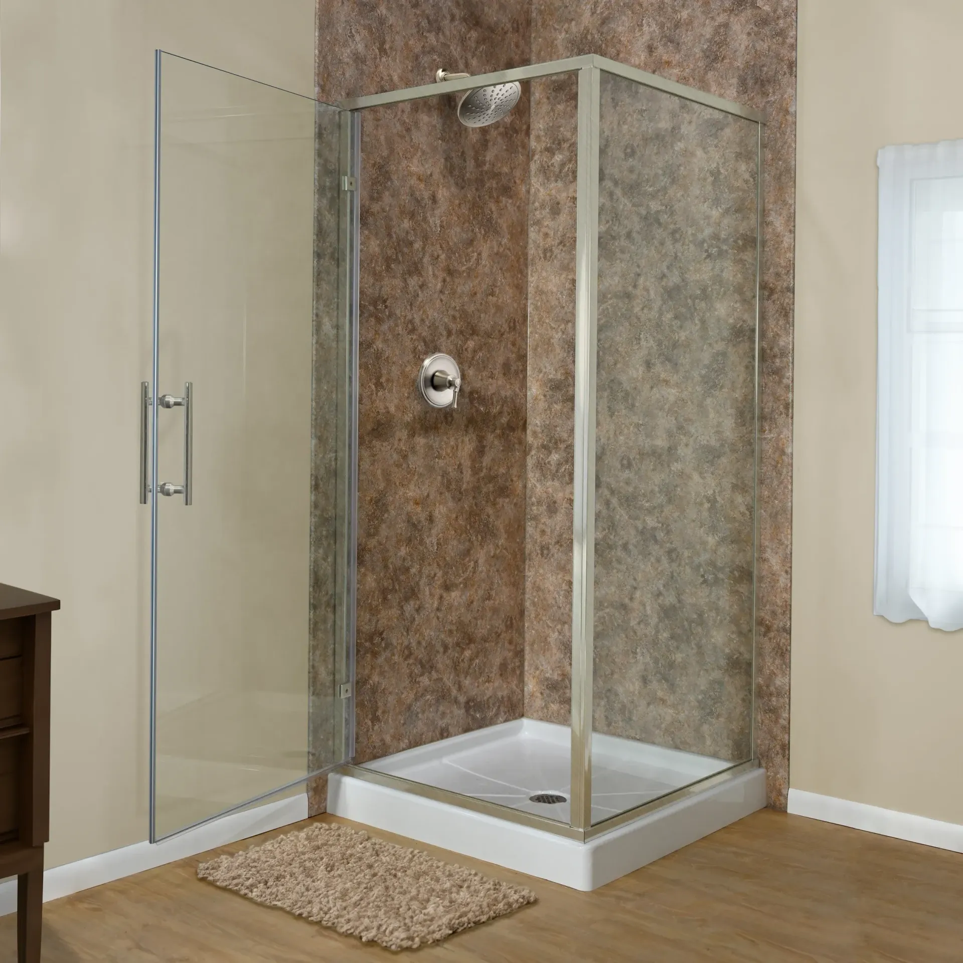 Modern bathroom with a glass shower enclosure, beige walls, and a tan bath mat